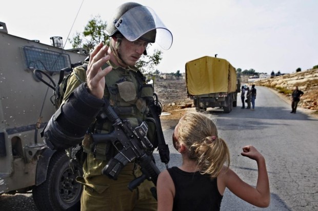 Palestinian girl punching Israeli soldier